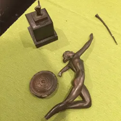 The bronze dancer figure broken into several pieces