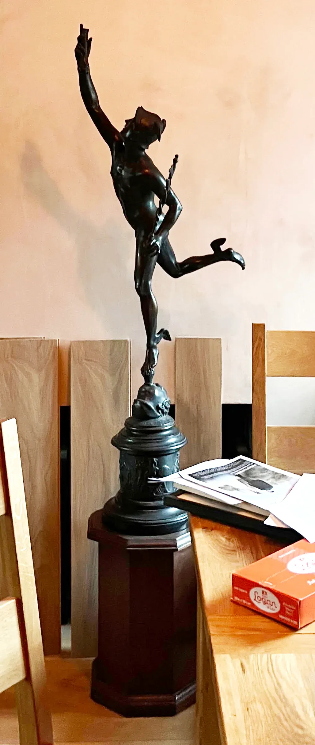 A very large bronze sculpture of Mercury requiring cleaning in situ