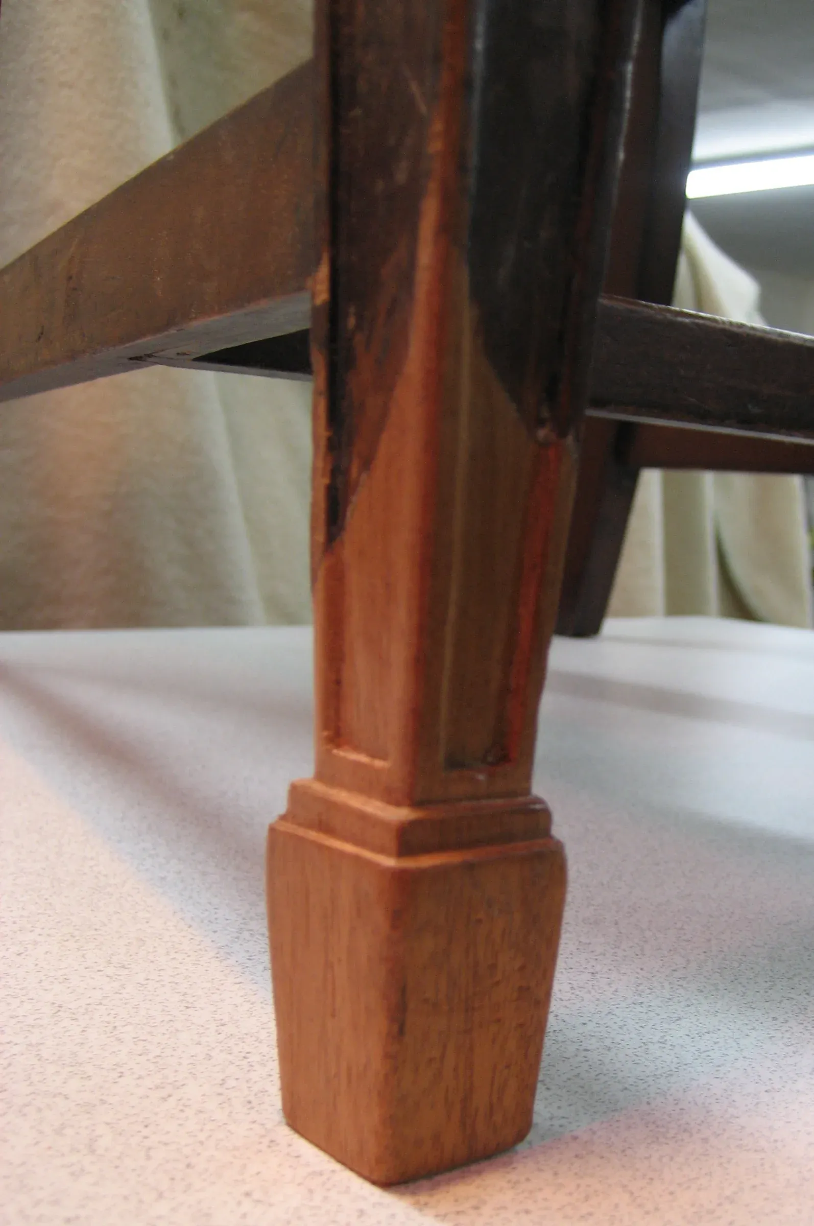 A replacement foot was carved from period mahogany and spliced into the leg