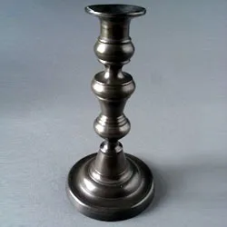 The pewter candlestick in one piece after repair
